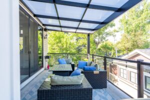 Covered balcony with outdoor seating and transparent roofing
