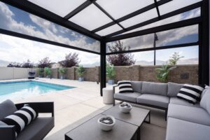 Covered poolside patio with modern sectional lounge seating.